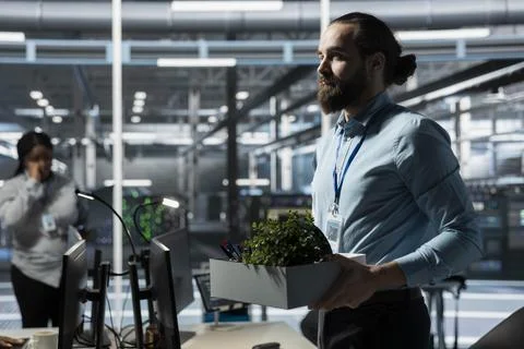 Data center technician leaving office after receiving job termination notice Stock Photos