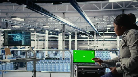 Data center technician monitors deep learning process with green screen laptop Stock Footage 314683704