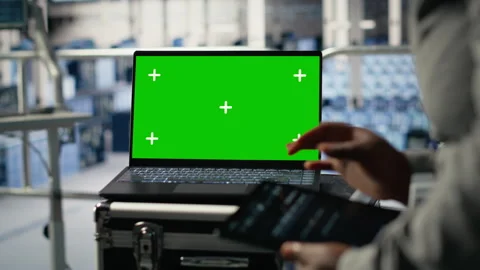 Data center technician monitors deep learning process with green screen laptop Stock Footage 314803259