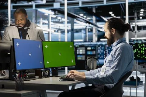 Data center technician programming diagnostic scripts on isolated screen PC Stock Photos