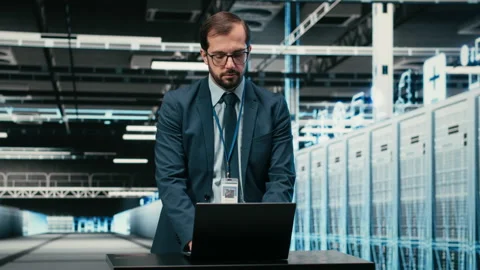 Data center technician uses laptop and augmented reality to upgrade server racks Stock Footage 329945000