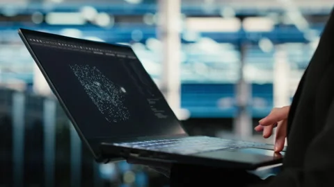 Data center technician using AI LLM assistant on laptop to troubleshoot issues Stock Footage 329325721