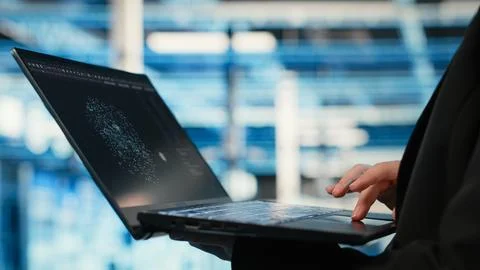 Data center technician using AI LLM assistant on laptop to troubleshoot issues Stock Photos