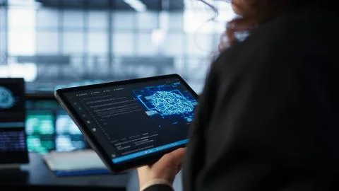 Data center technician using artificial intelligence on tablet, close up Stock Photos