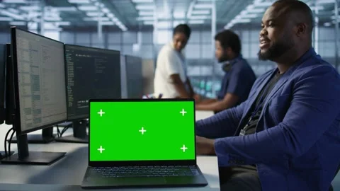 Data center technician using chroma key laptop, maintaining company network Stock Footage 319546899