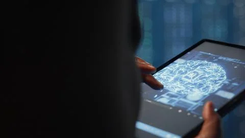 Data center technician using machine learning on tablet to optimize operations 写真素材