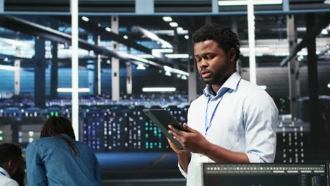 Data center technician using tablet to do node tree programming Stock Footage 307021081