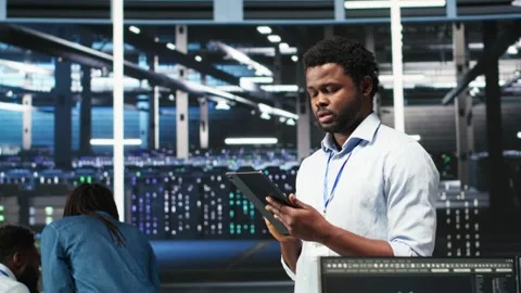 Data center technician using tablet to do node tree programming Stock Footage 309118032