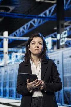 Data center technician using tablet to review equipment diagnostics Stock Photos