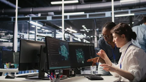 Data center technicians adjusting blade server hardware powering AI Stock Footage 309637554