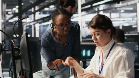 Data center technicians adjusting blade server hardware powering AI Stock Footage 309777886