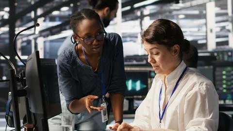 Data center technicians adjusting blade server hardware powering AI Stock Photos
