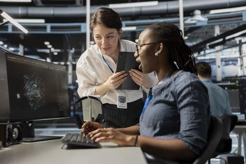 Data center technicians look at visualization on PC screen Foto stock