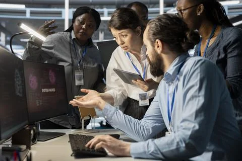 Data center technicians reacting to virus alert on computer monitor Stock Photos