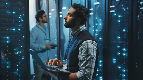 At data center two men server specialists inspecting working system and hardware Stock Footage 119278648