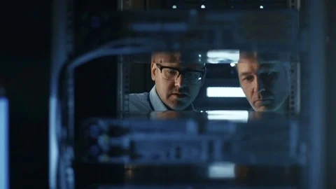 In Data Center Two Server Technicians Install Additional Hardware into Server  Stockbeeldmateriaal 74630362