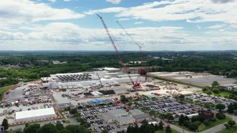 Data center under construction in Lancaster with two crawler cranes, modular Stock Footage 337529221