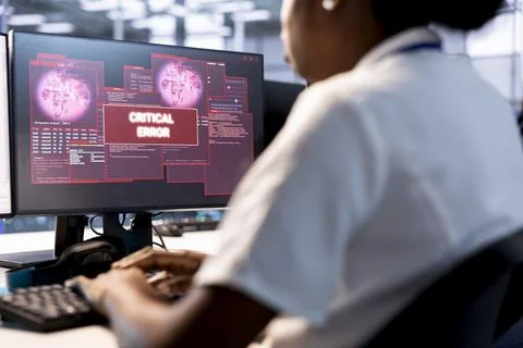 Data center worker fixing critical error, trying to mitigate security risks Foto stock