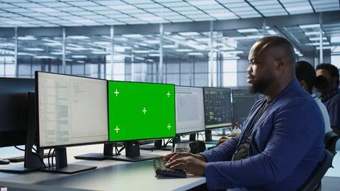 Data center worker looking at mockup PC, monitoring performance 스톡 사진