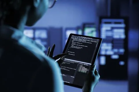 Data center worker runs code Stock Photos