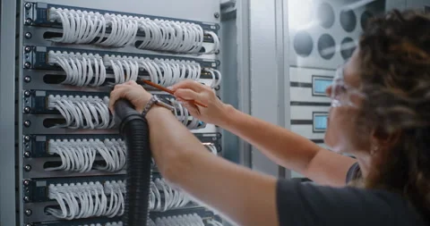 Data Center Worker in Safety Goggles Performing Routine Hardware Sanitation Stock Footage 344882711