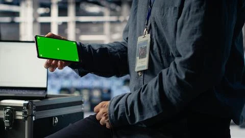 Data center worker uses isolated screen smartphone while deploying deep learning Foto stock