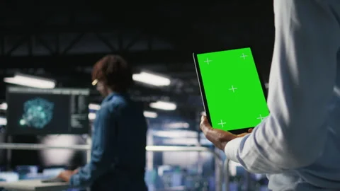 Data center worker using green screen mockup tablet, doing maintenance, closeup Stock Footage 310276991
