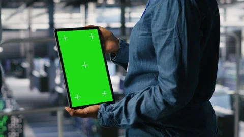 Data center worker using green screen mockup tablet, doing maintenance, closeup Stock Footage 310277202