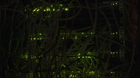 Data CenteSwitchboard panel with chaotic mess cables Flashing LED Lights At Dark Stock-Footage 102148476