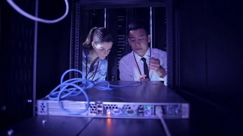 Data Centre with rows of servers and technicians Stock Footage 75341584