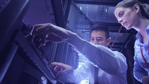 Data Centre with rows of servers and technicians Stock Footage 75376044