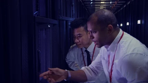Data Centre with rows of servers and technicians Stock Footage 75409512