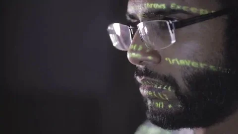 Data code reflection on programmers face. Hackers in glasses hacking programm Video stock 69207345