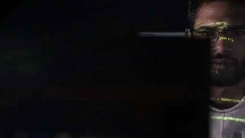 Data code reflection on programmers face. Hackers in glasses hacking programm Stock Footage 69208193