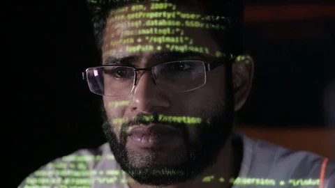 Data code reflection on programmers face. Hackers in glasses hacking programm Video stock 71583512