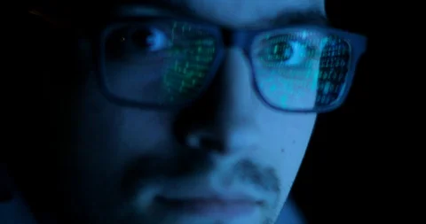 Data code reflection in programmers, hackers glasses. Man is looking at camera. Stock Footage 105303339