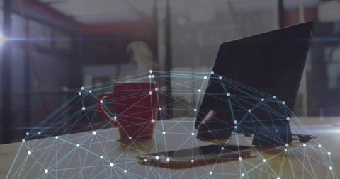 Data connectivity nodes streaming across office desk, showing red coffee mug, Stock Footage 329989660