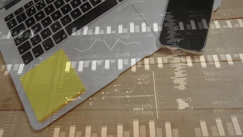 Data-driven desk being animated with laptop keyboard, phone, sticky notes and Stock Footage 307858447