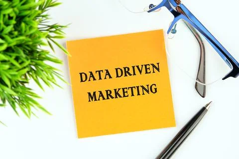 DATA DRIVEN MARKETING text on a yellow sticker on a light background next to  Stock Photos