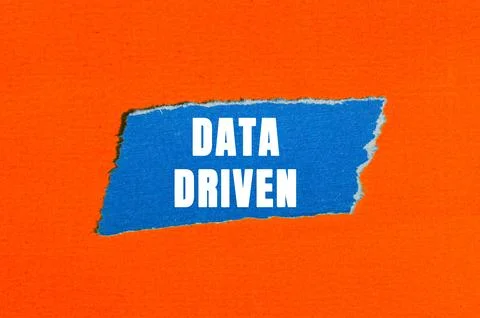 Data Driven message written on ripped torn paper background. Conceptual Dat.. Stock Photos