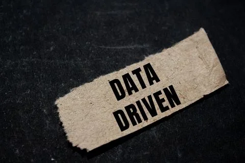 Data Driven message written on ripped torn paper background. Conceptual Dat.. Stock Photos