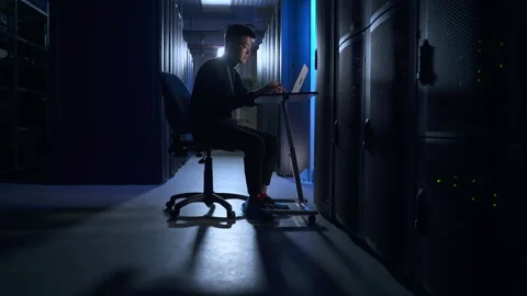 Data engineer or programmer working with laptop and checking equipment, sitting Stock Footage 168516236