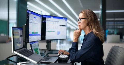 Data Engineer Reviews Real-time Pipeline Workflows On Laptop At Desk. Stock Photos