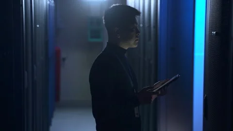 Data engineer using tablet and doing network diagnostics while standing in Stock Footage 166837355