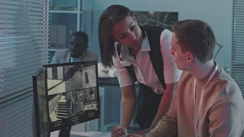 Data Engineers Discussing Info on CCTV Cameras in Dark Office Stock Footage 246681256