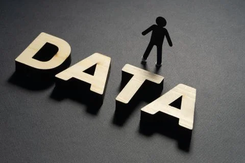DATA letters in front of a human paper figures on black background. Personal Stock Photos