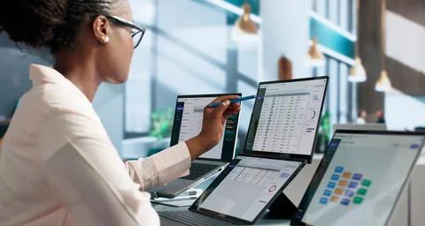 Data Manager Confidently Reviews Catalog Metadata Using Dual Touchscreen Lapt Stock Photos