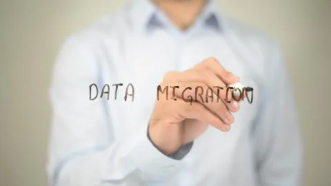 Data Migration, man writing on transparent screen Stock Photos