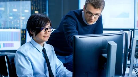 In the Data Mining Center Chief Statistician Consults His Young Assistant sit 写真素材