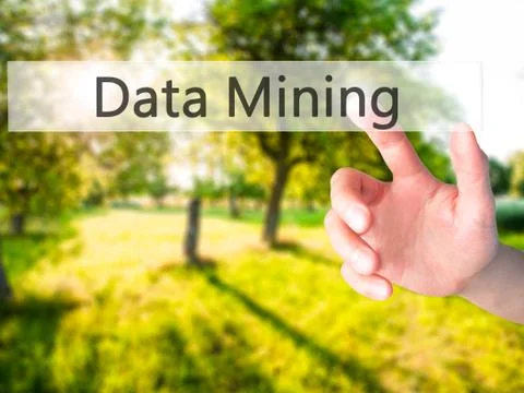 Data Mining - Hand pressing a button on blurred background concept on visual  写真素材